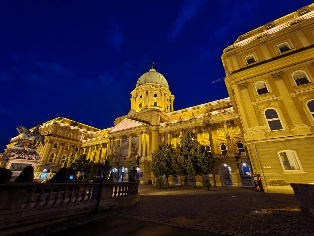 Buda Castle's central dome lit up against the night sky, Budapest
