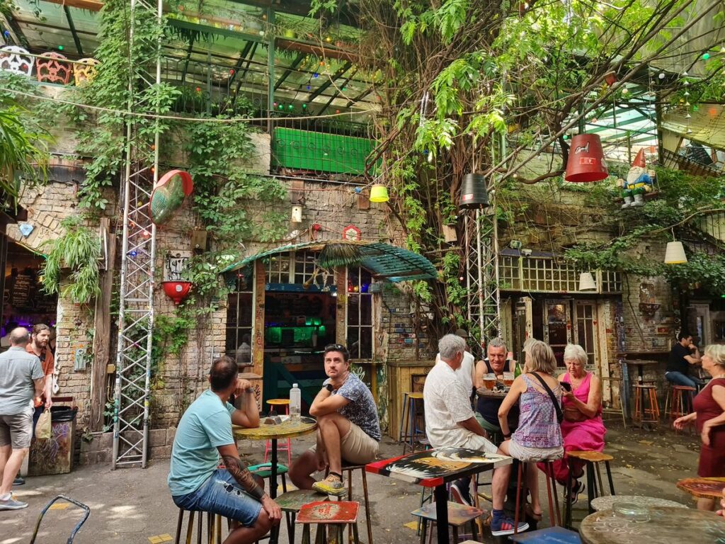 Szimpla Kert ruin bar courtyard in daylight, Budapest Jewish Quarter