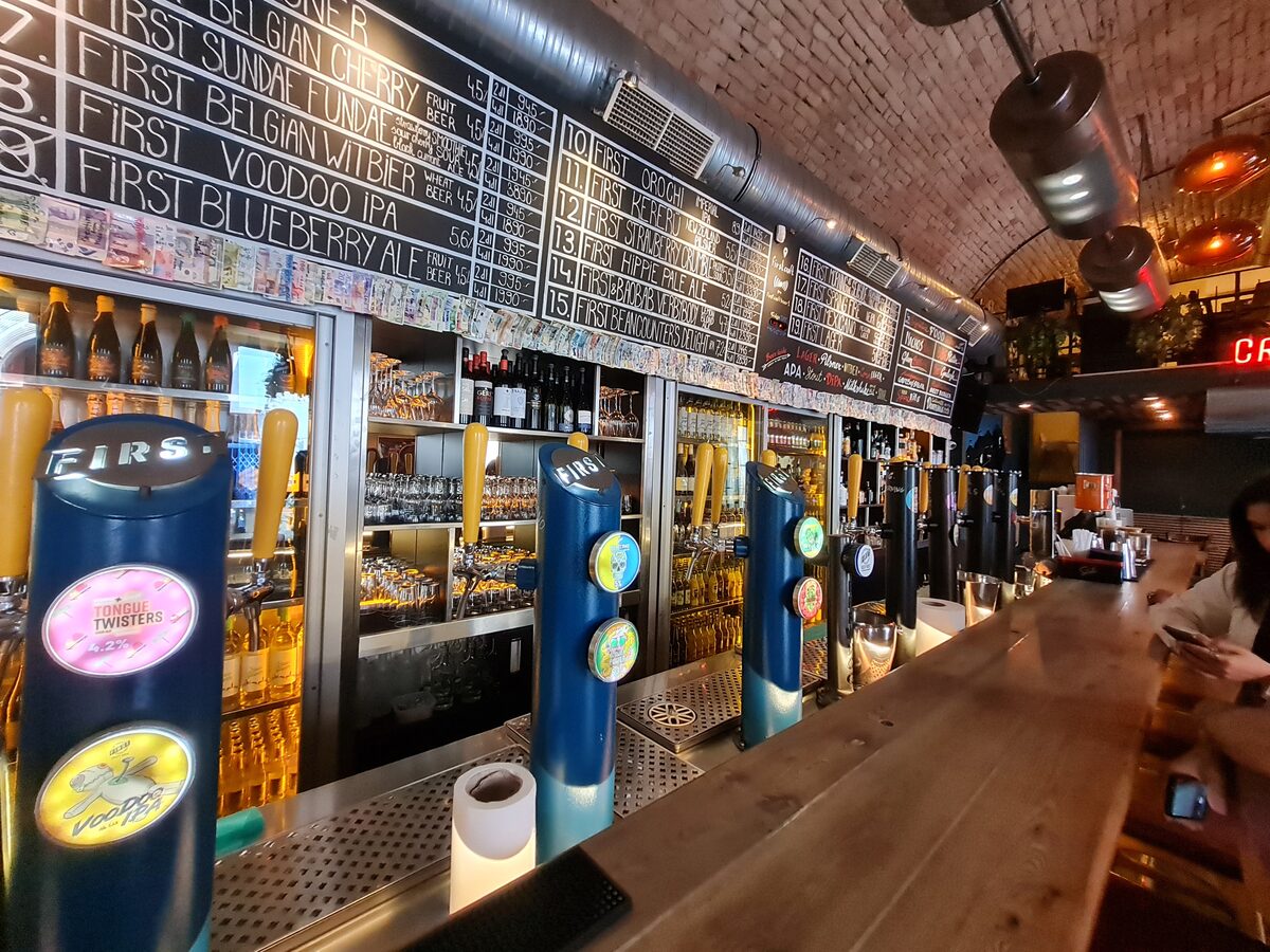 Nineteen tap handles at First Craft Beer and BBQ Budapest with chalk menu board showing all own-brand beers