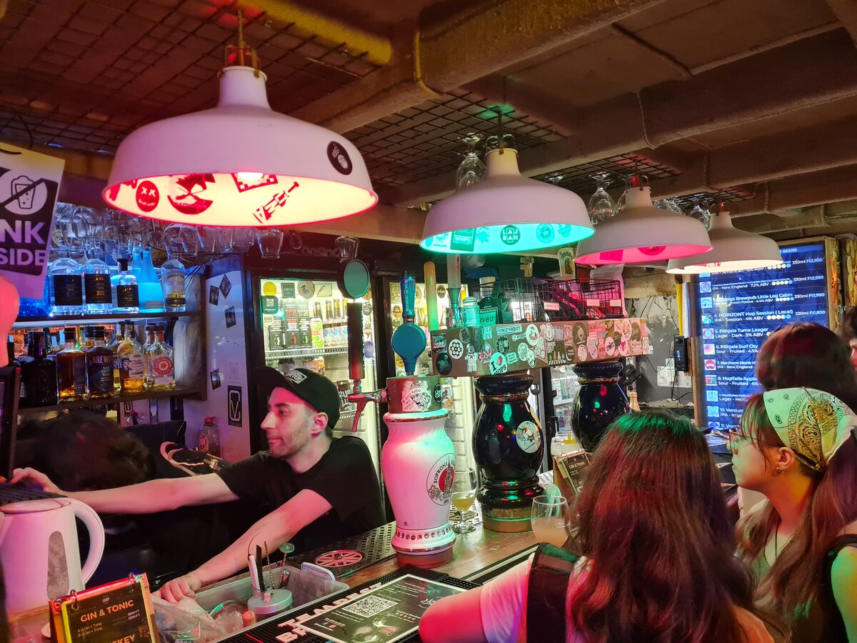 Bartender serving craft beer at HOPS Beer Bar Budapest