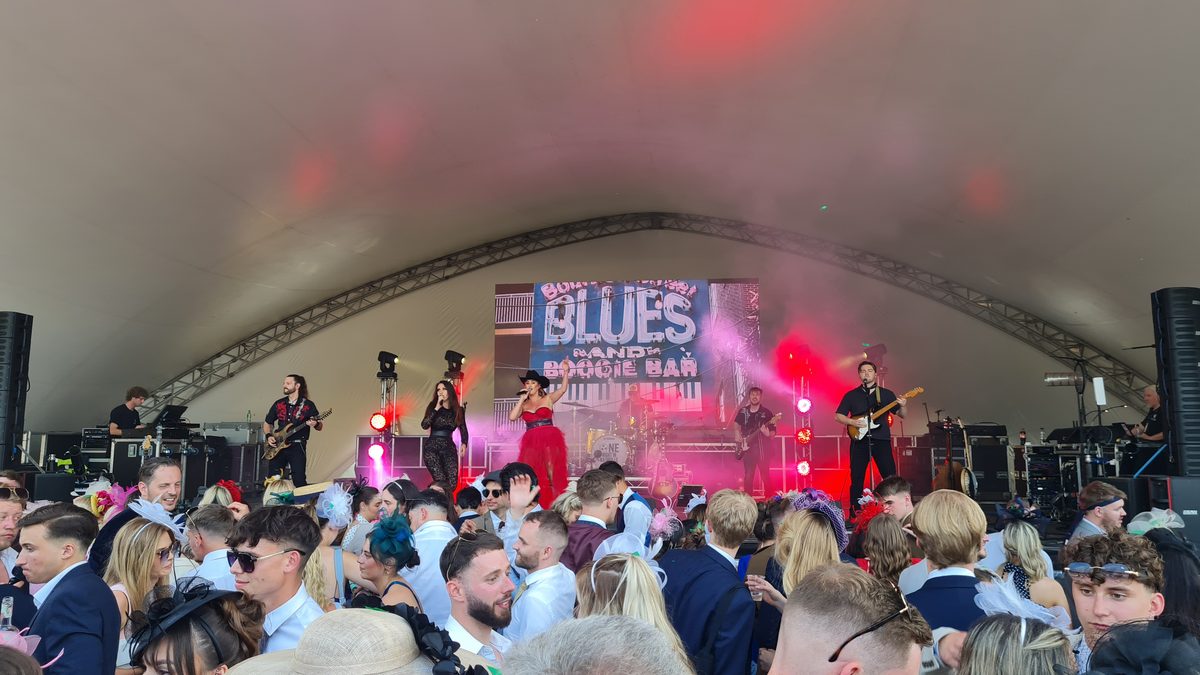 Blues Band and Boogie Bar performing on the Village Enclosure main stage at Royal Ascot with red stage lighting