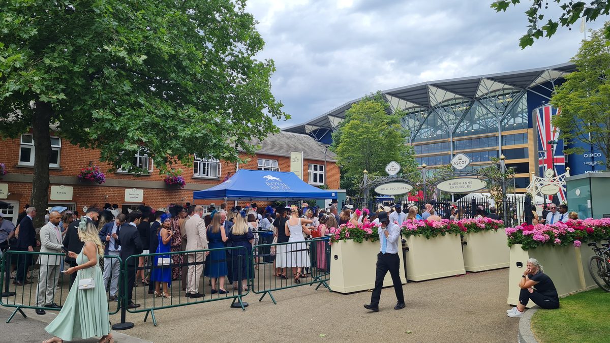 Queue at Royal Ascot entrance with Royal Enclosure and Queen Anne Enclosure signs