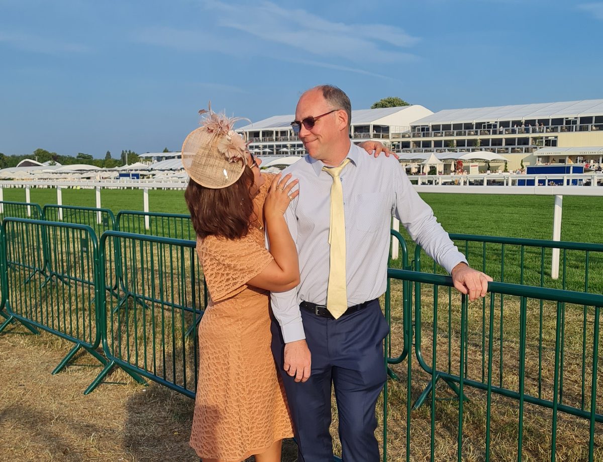 Olesia and Ian at Royal Ascot Village Enclosure — Olesia in a peach dress with beige fascinator, Ian in a blue suit and yellow tie