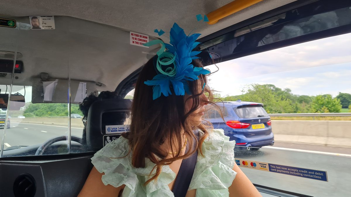 Blue feather fascinator worn in a London black cab en route to Royal Ascot