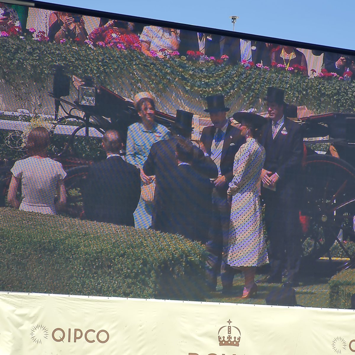 Big screen at Royal Ascot showing the Prince and Princess of Wales arriving in the 2022 Royal Procession
