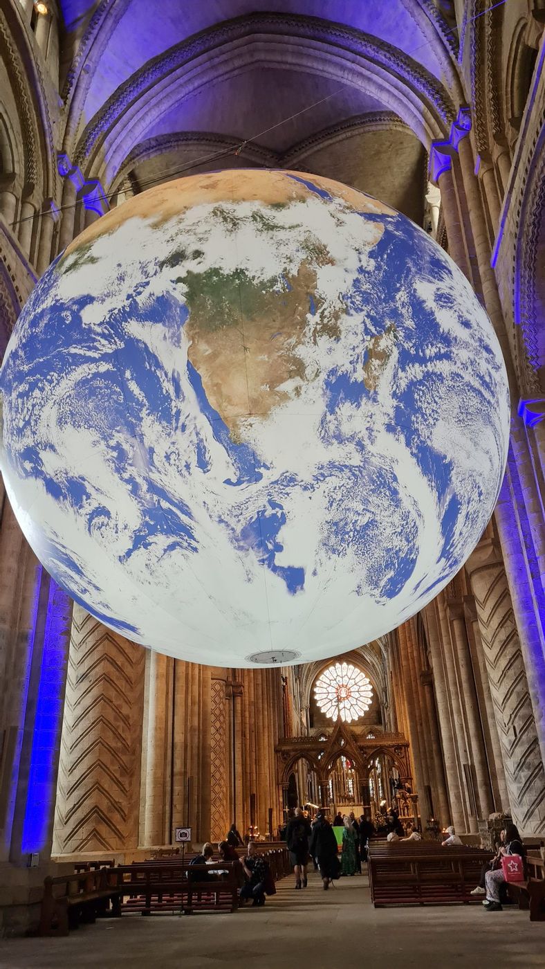 The Gaia artwork, a large illuminated globe of the Earth, suspended inside Durham Cathedral