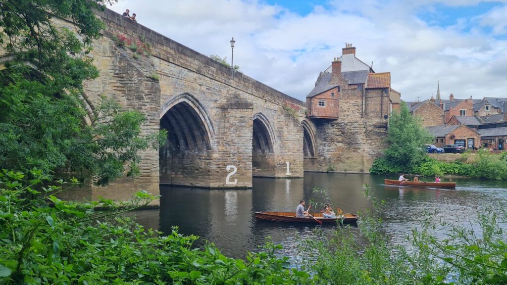 The arches of Elvet Bridge reflected in the river
