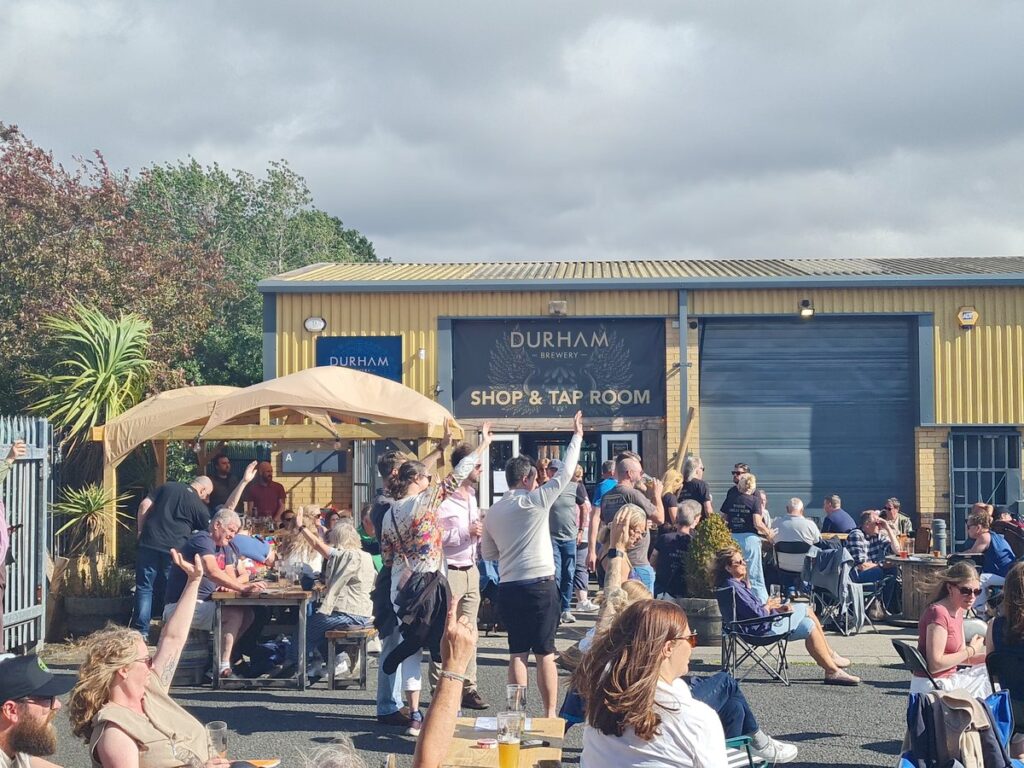 Durham Brewery shop and tap room building at Bowburn with a crowd outside