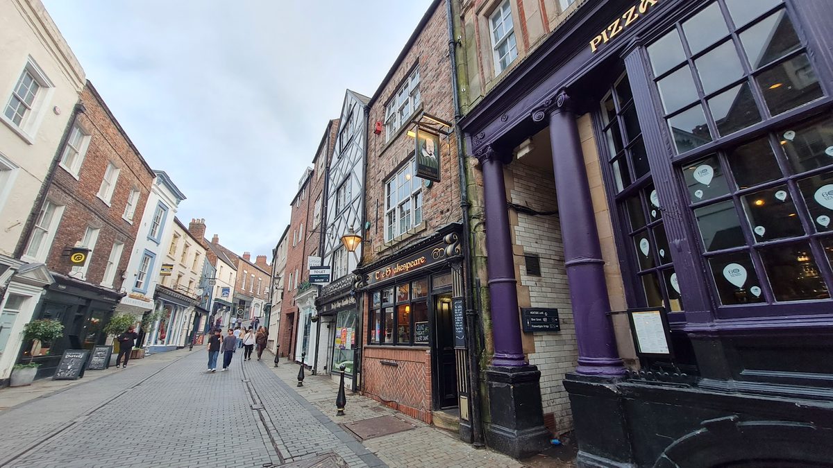 Historic pub and shop frontages along Saddler Street, Durham