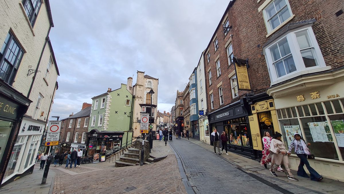 Saddler Street in Durham curving uphill between old buildings towards the cathedral