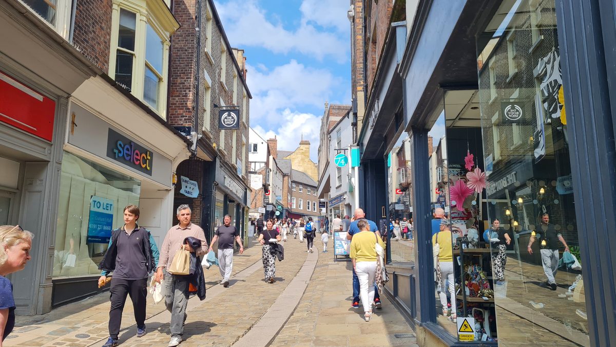Shoppers on Silver Street, Durham, looking downhill from the Market Place