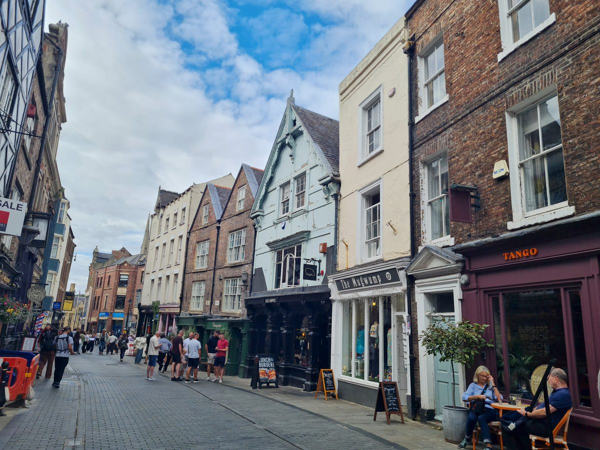 Old gabled upper storeys above the shopfronts on a street in central Durham
