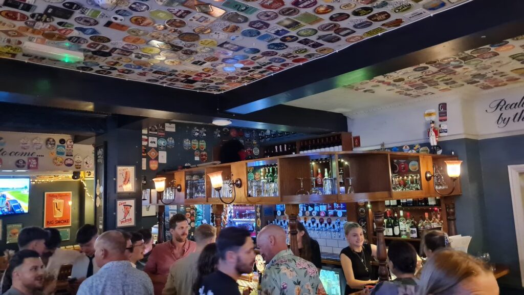 The Corner House Windsor — packed bar with crowd at the taps at night