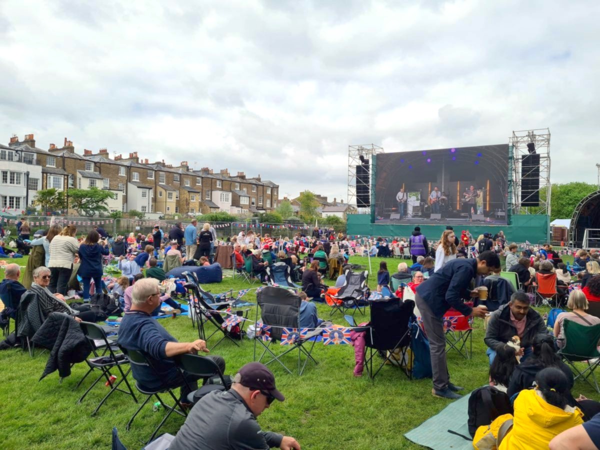Crowds with picnic chairs on the grass at the coronation concert, Windsor Great Park