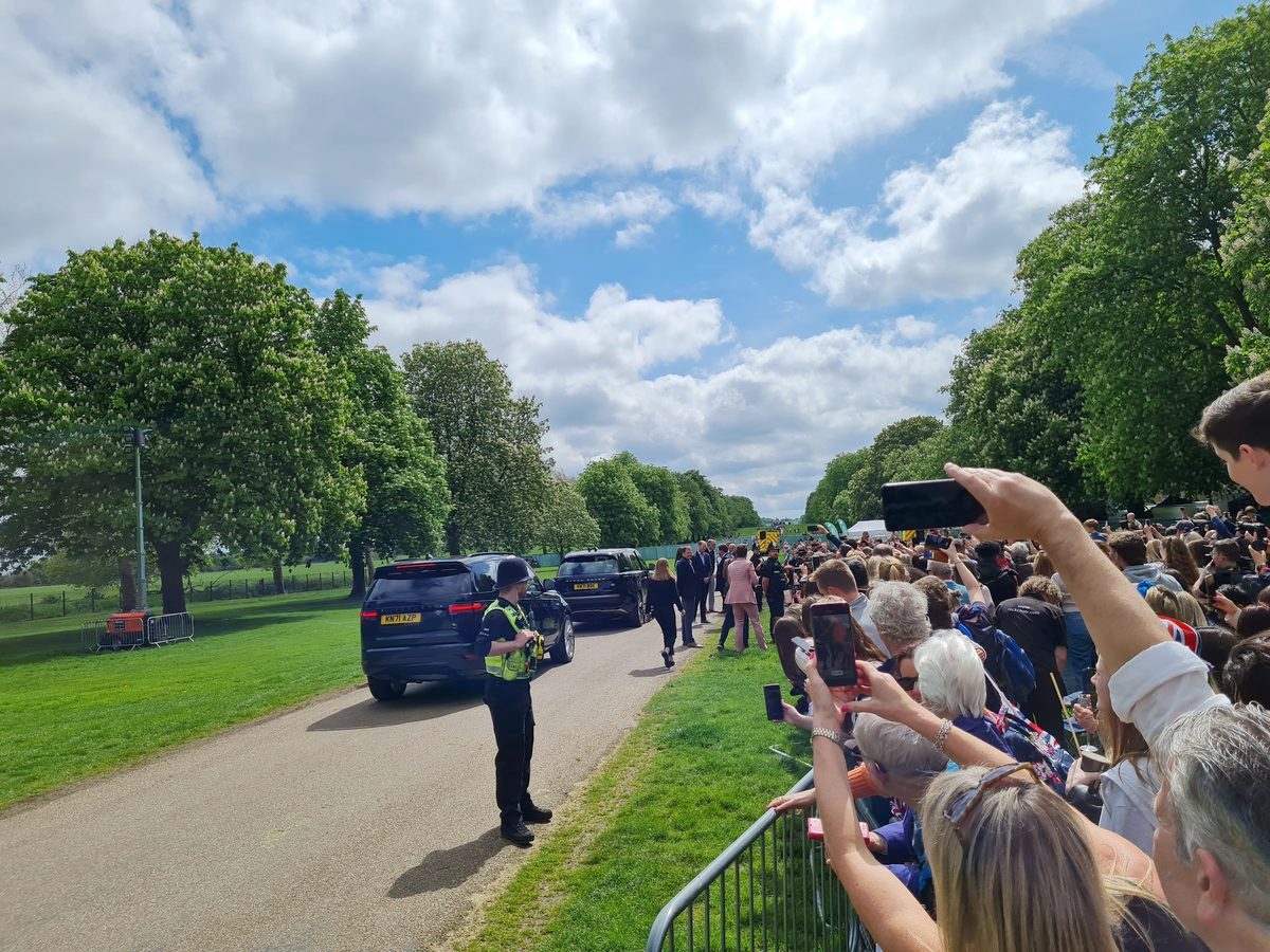 Black cars of the royal convoy stopped on the road beside the Long Walk, Windsor