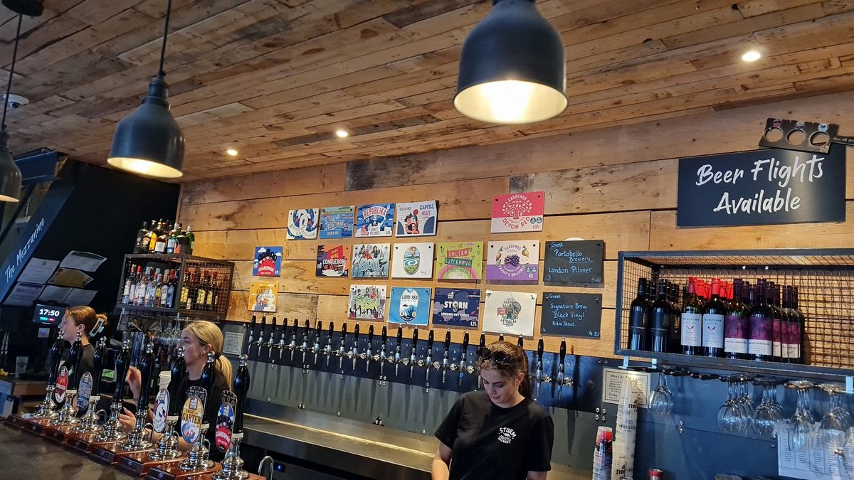 Windsor and Eton Brewery taproom — long tap wall with beer flight menu and mezzanine level