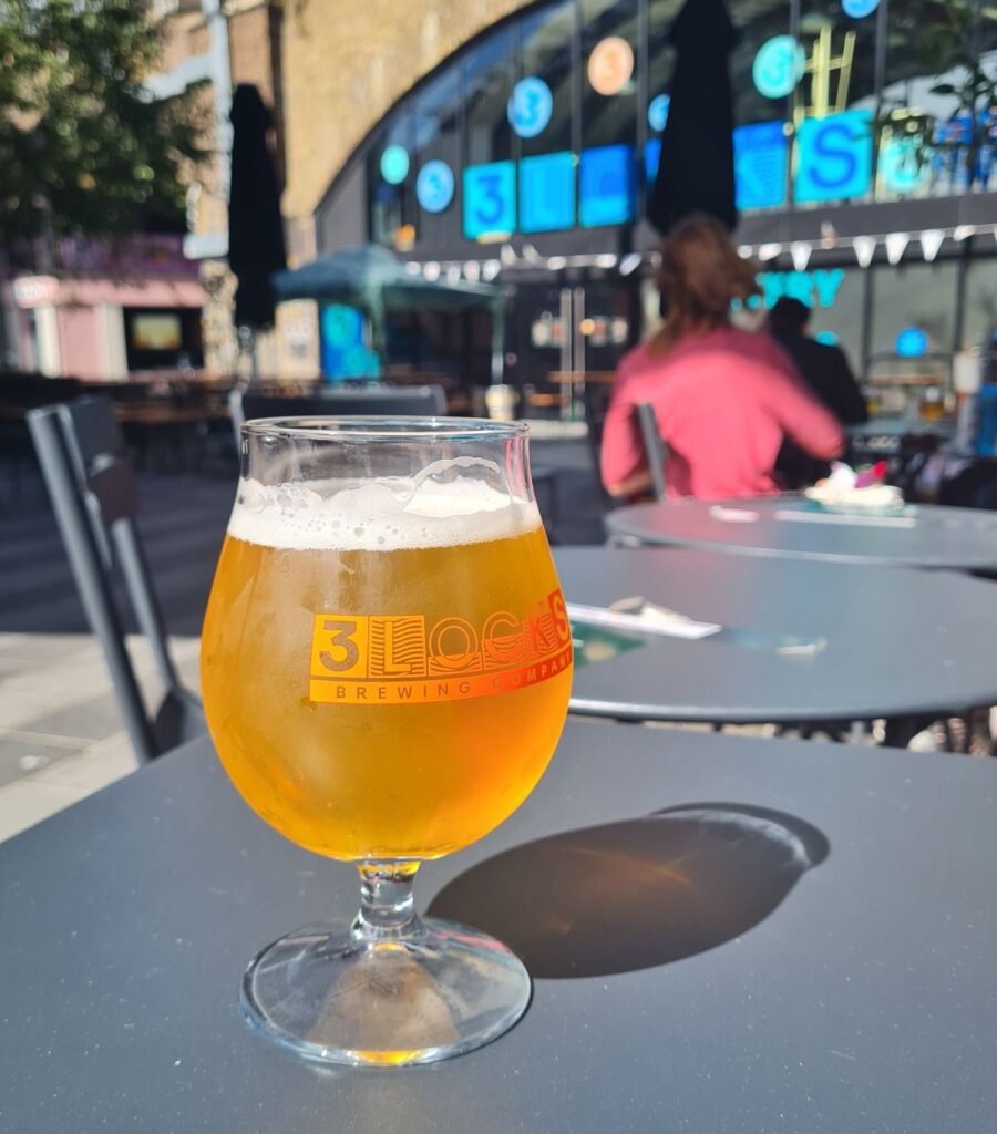 A single glass of craft beer in the sun at 3 Locks Brewing, Camden