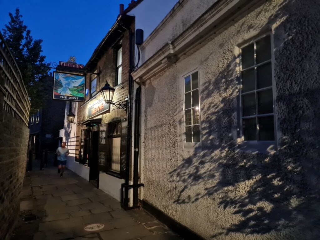 The Dove pub sign and lantern in the narrow lane at Upper Mall, Hammersmith, at dusk