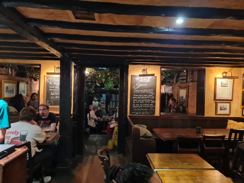 The beamed main bar at The Dove, Hammersmith, with locals at the tables