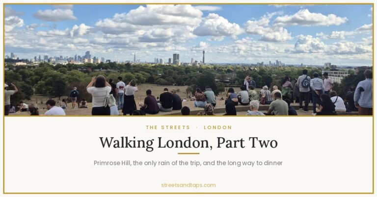 The view from the top of Primrose Hill over the London skyline, with people sitting along the crest of the hill