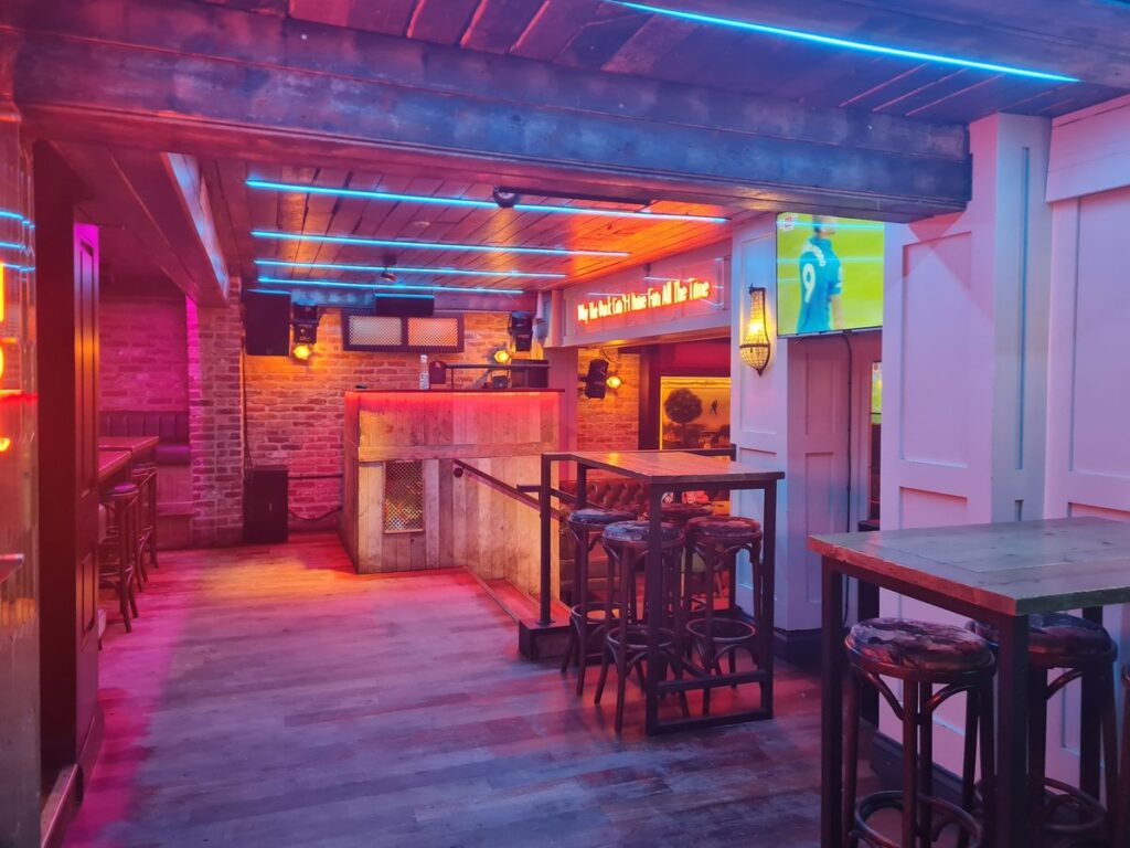 Neon-lit interior of The Drunken Duck on Claypath, Durham