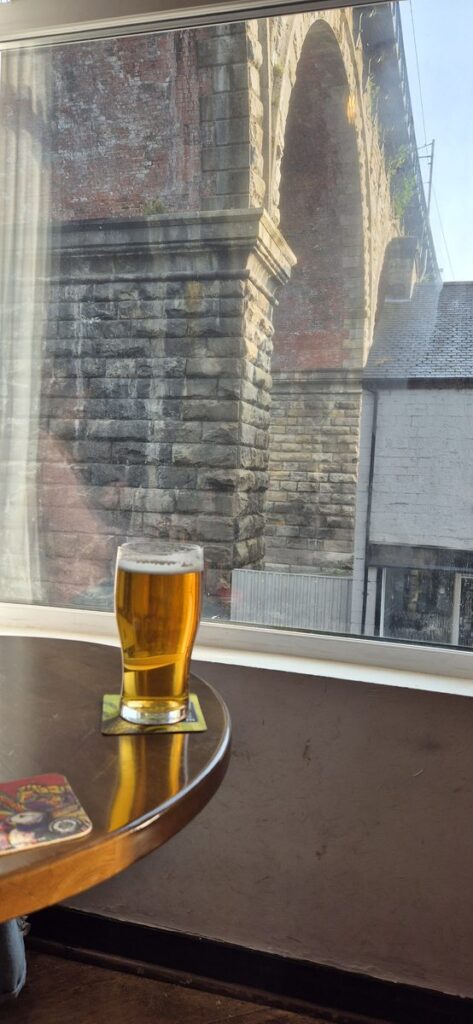 A pint on the windowsill at The Station House with the railway viaduct through the window, Durham