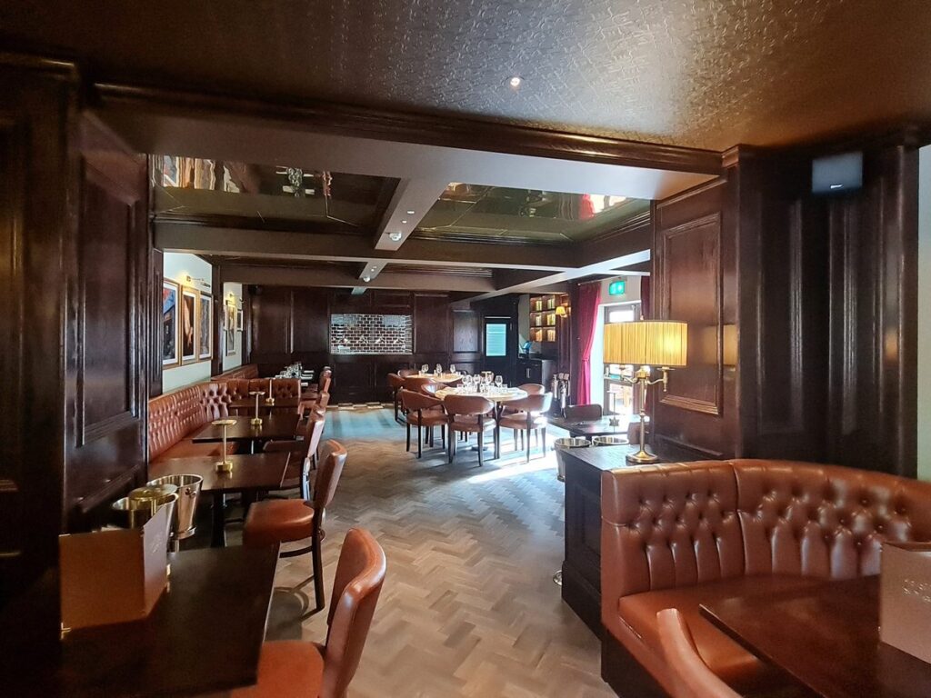 Dark wood panelling, leather banquettes and parquet flooring inside The Court, Durham