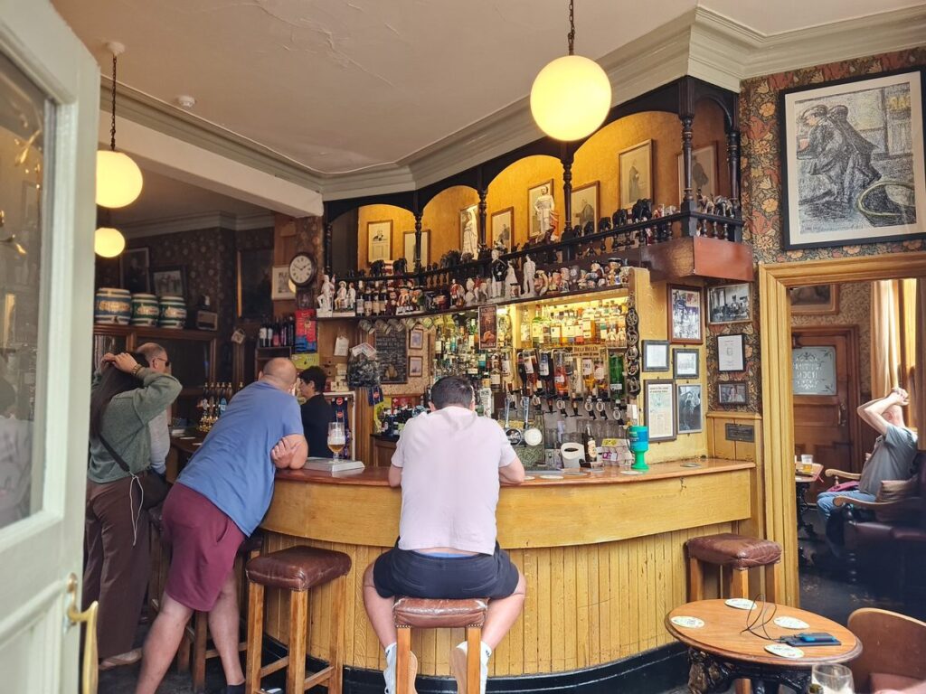 The curved wooden bar and arched back bar at The Victoria Inn, Durham