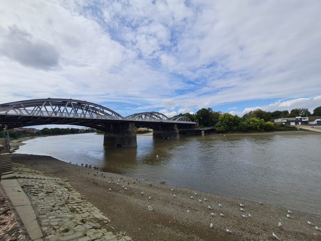 Barnes Bridge across the River Thames at low tide, London
