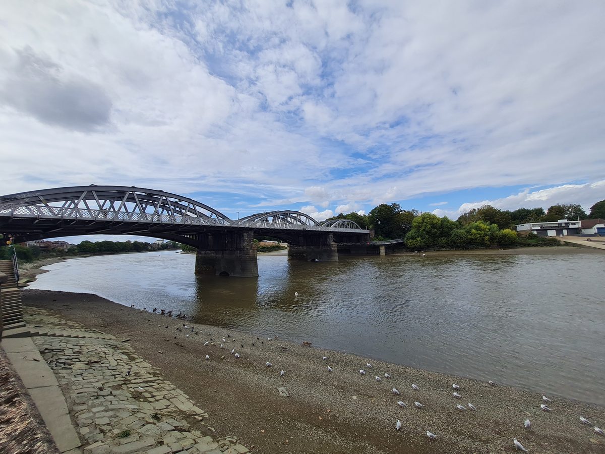 Barnes Bridge across the River Thames at low tide, London