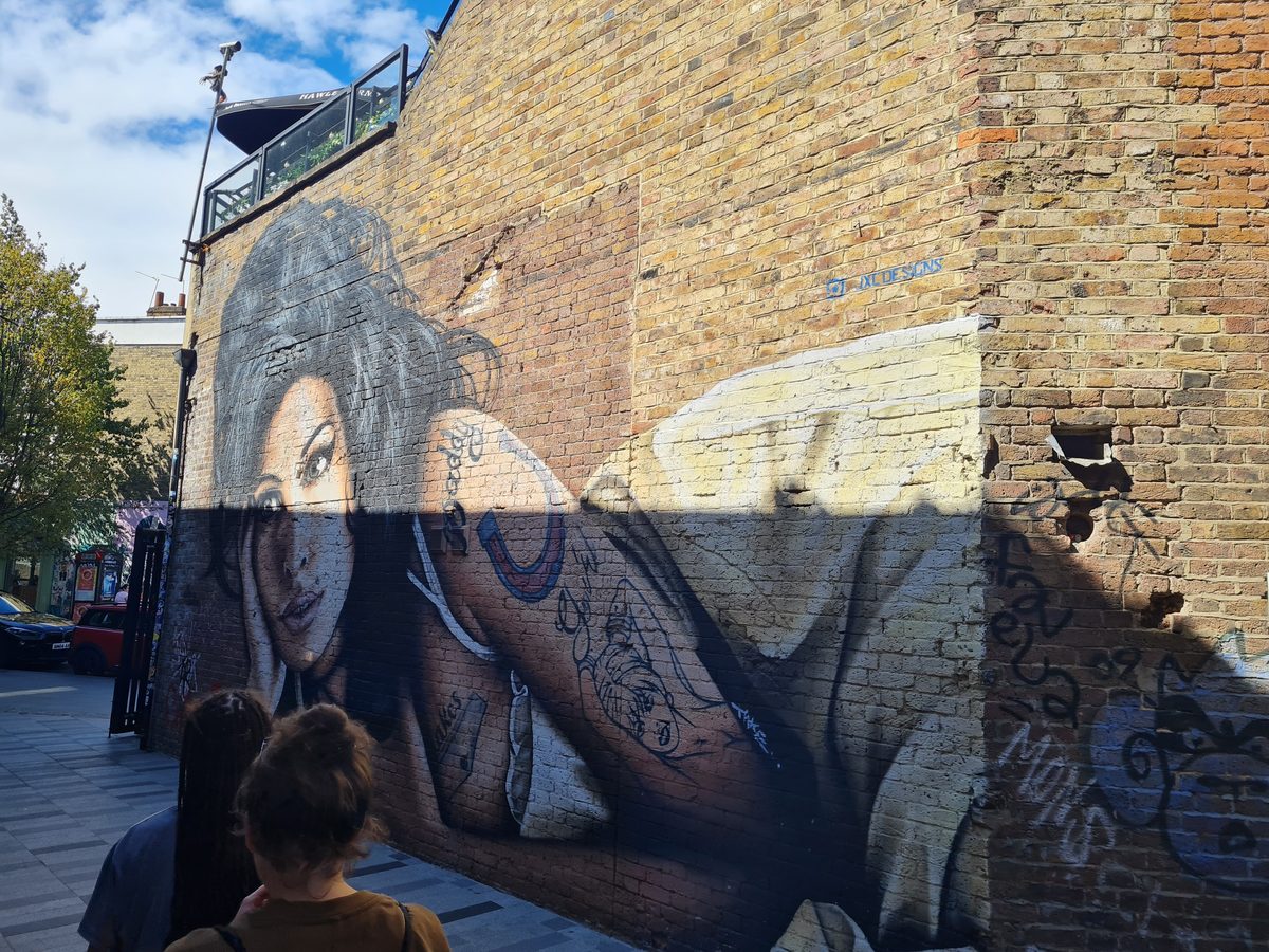 Amy Winehouse mural on a brick wall in Camden, London