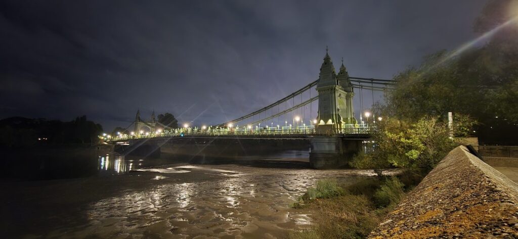 Hammersmith Bridge lit up at night over the River Thames, London