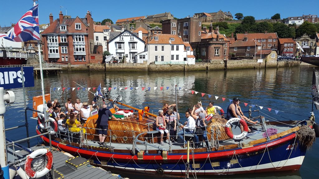 Whitby harbour with a boat in a sunny day