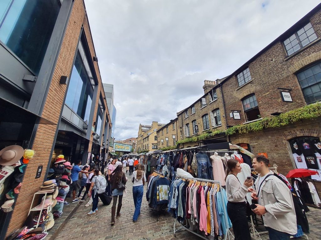 Rails of vintage clothing and hats for sale in the Stables Market, Camden, London