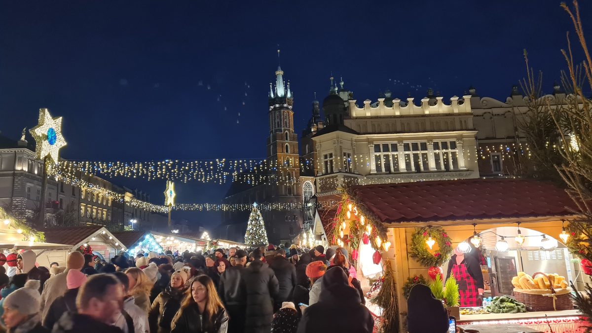 Christmas lights over the market stalls and the Cloth Hall at night, Kraków