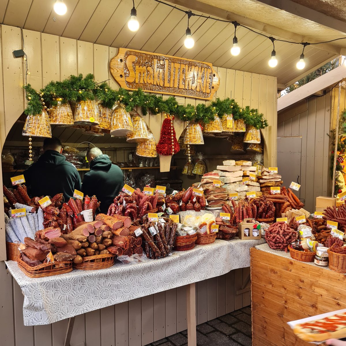 Smoked cheeses and cured meats on a Kraków Christmas market stall
