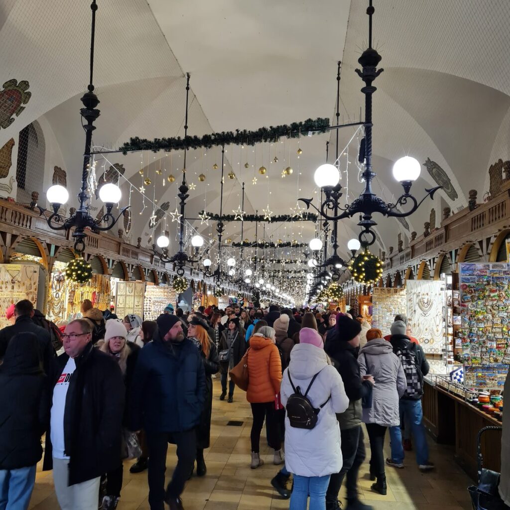 Stalls under the chandeliers inside the Cloth Hall, Kraków
