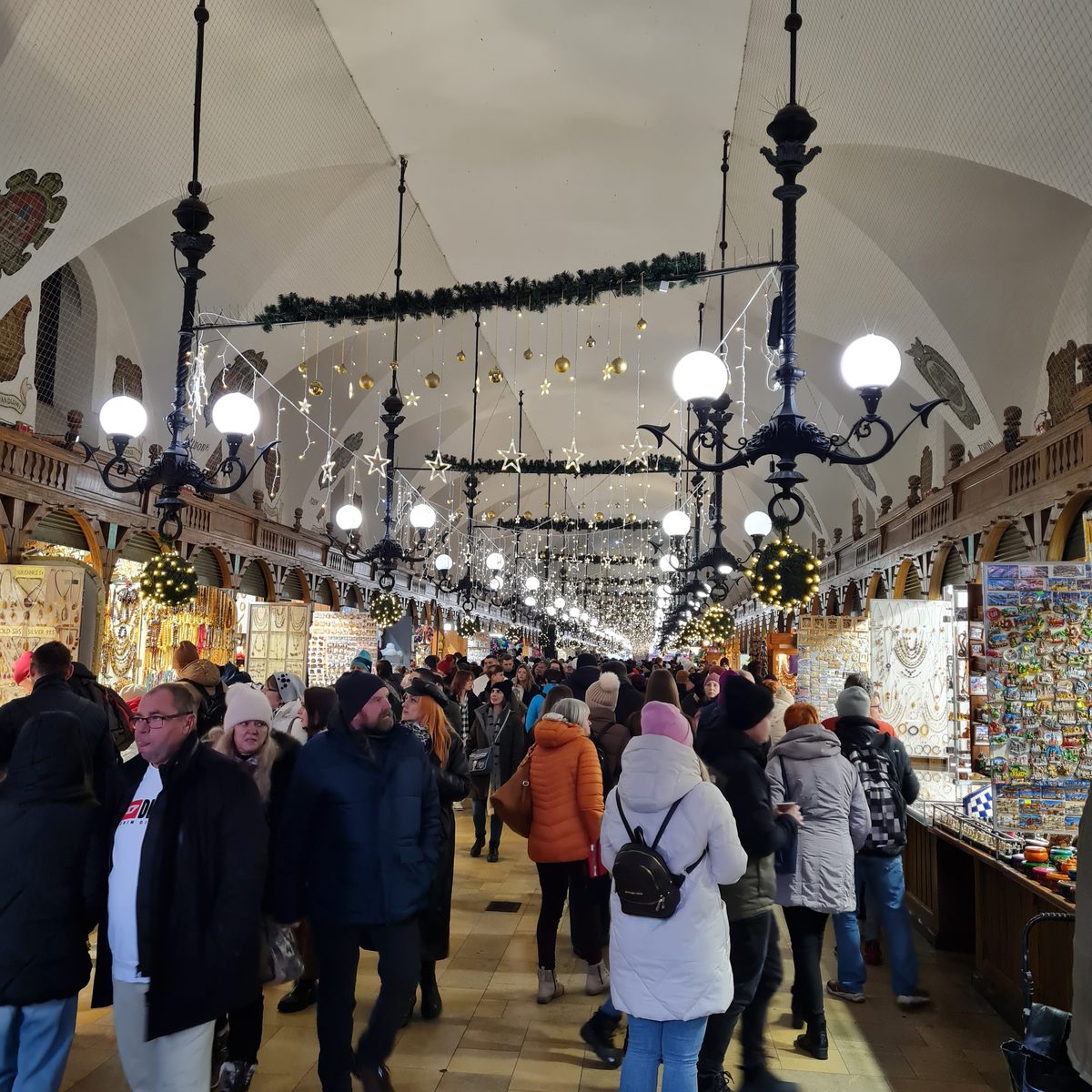 Stalls under the chandeliers inside the Cloth Hall, Kraków