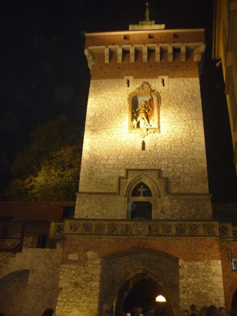 The Florian Gate, the old way into Kraków's Old Town, lit up at night
