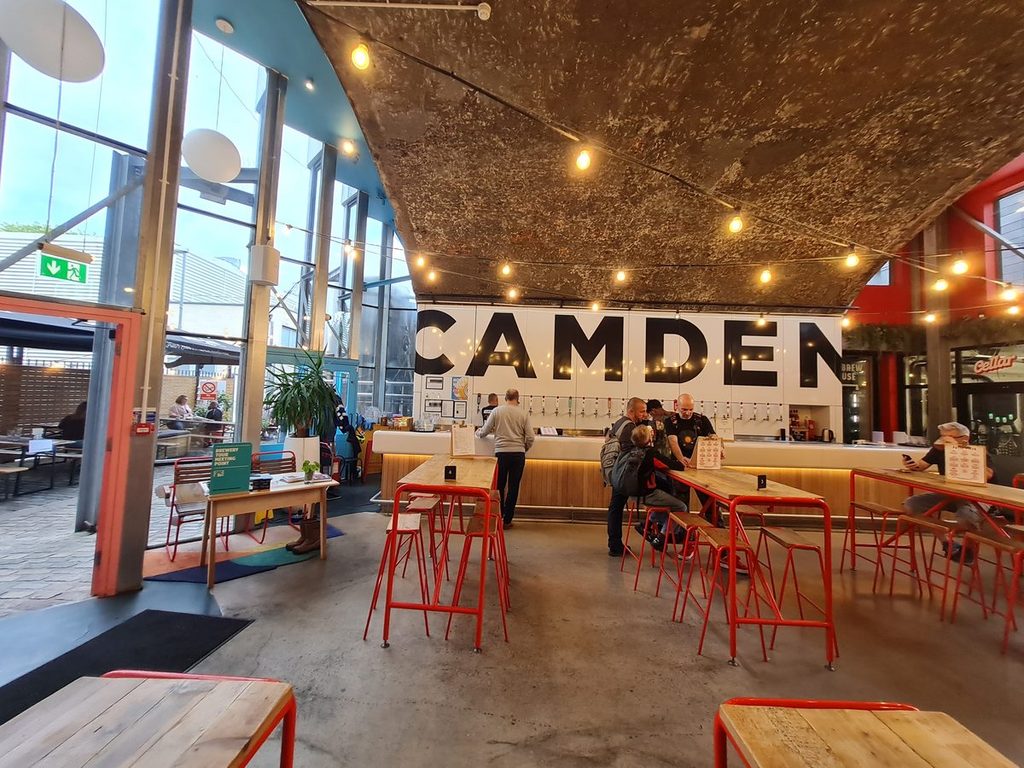 The beer hall at Camden Town Brewery in Kentish Town, London, with the Camden sign behind the bar