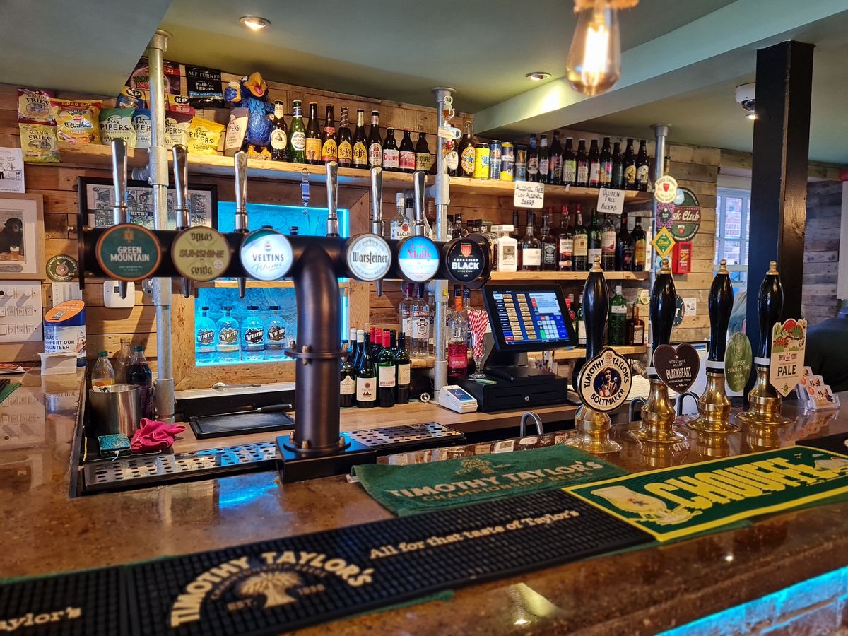 Keg taps and four hand pulls behind the bar at Beer O’Clock micropub, Whitby