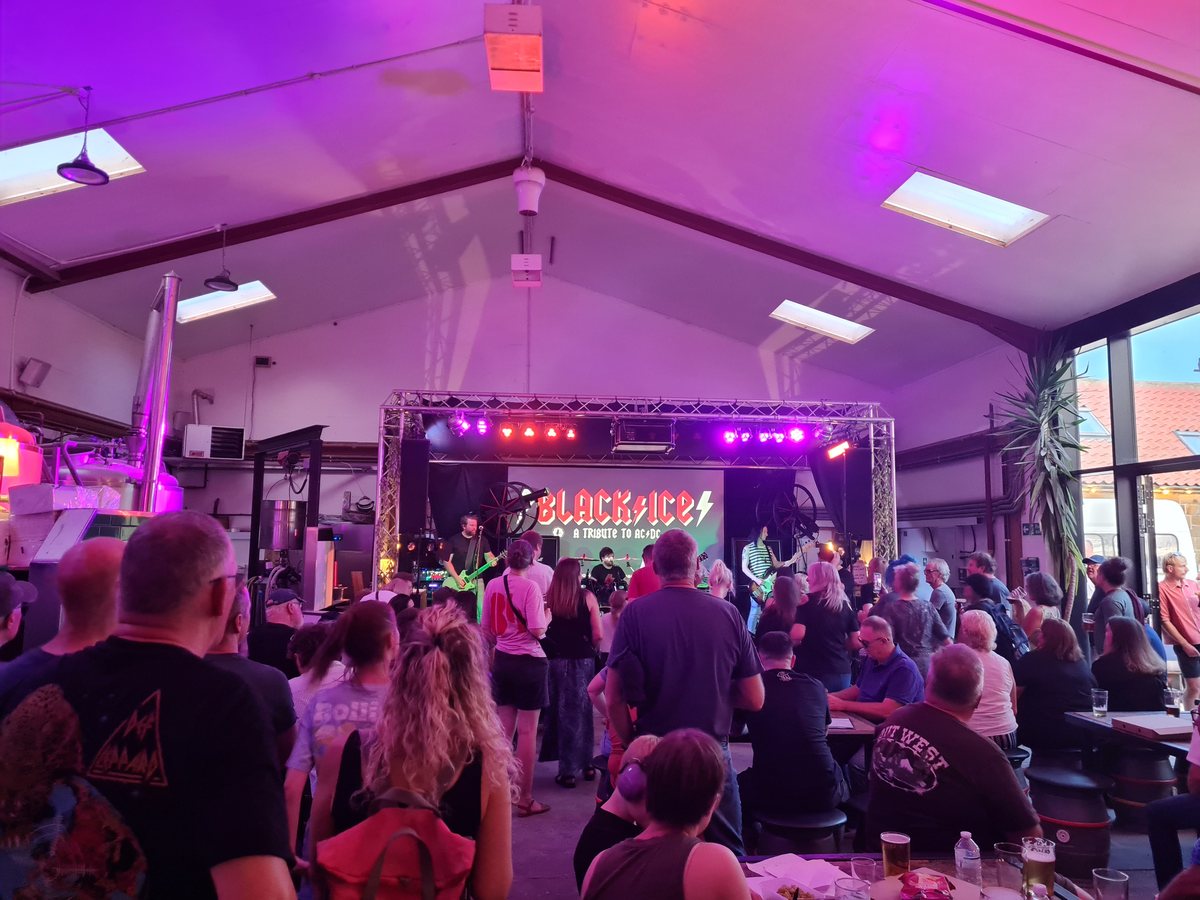Live tribute band playing to a crowd at Whitby Brewery