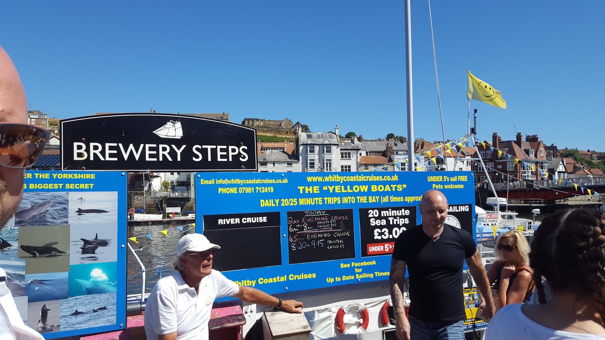 The Whitby Coastal Cruises ticket board at Brewery Steps, advertising the yellow boats and daily twenty minute trips into the bay