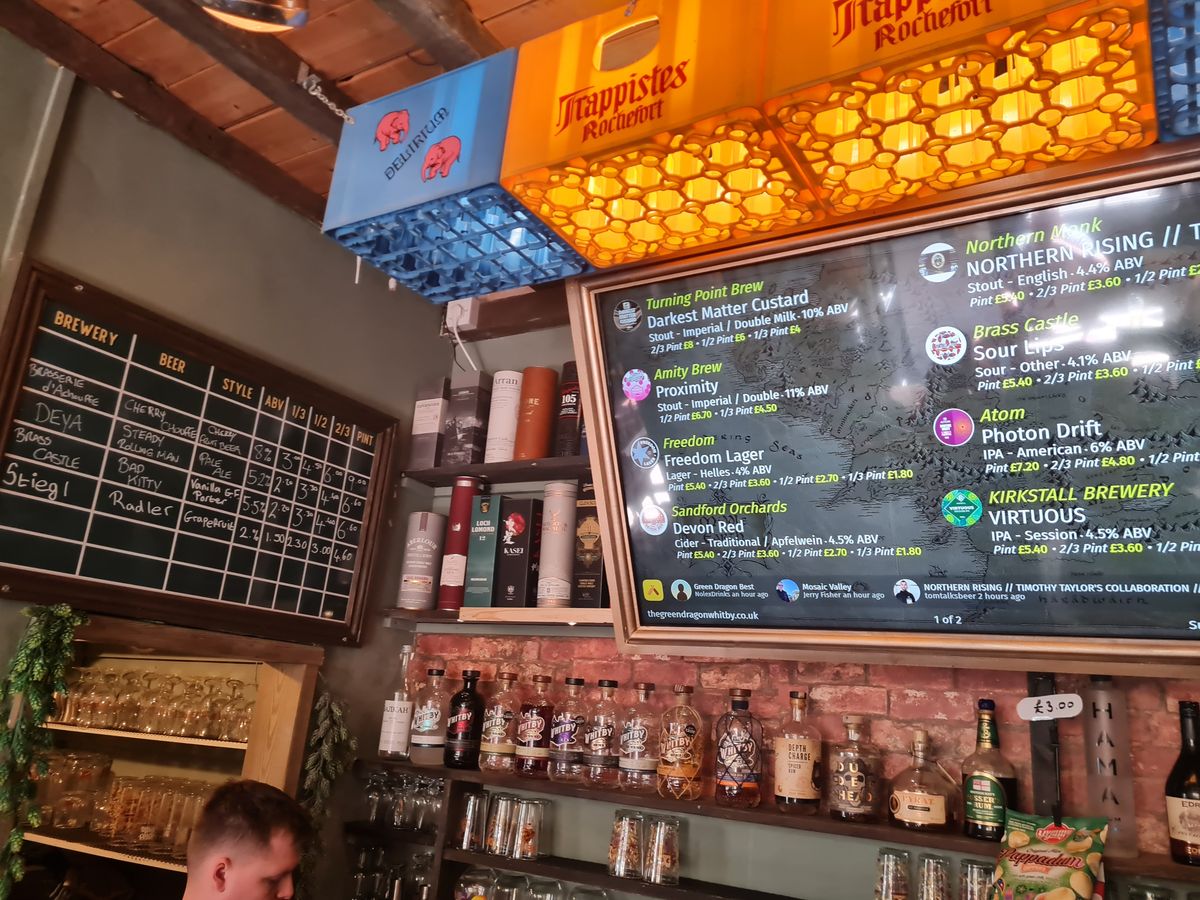 Digital and chalk tap boards listing craft beers at the Green Dragon Ale House, Whitby