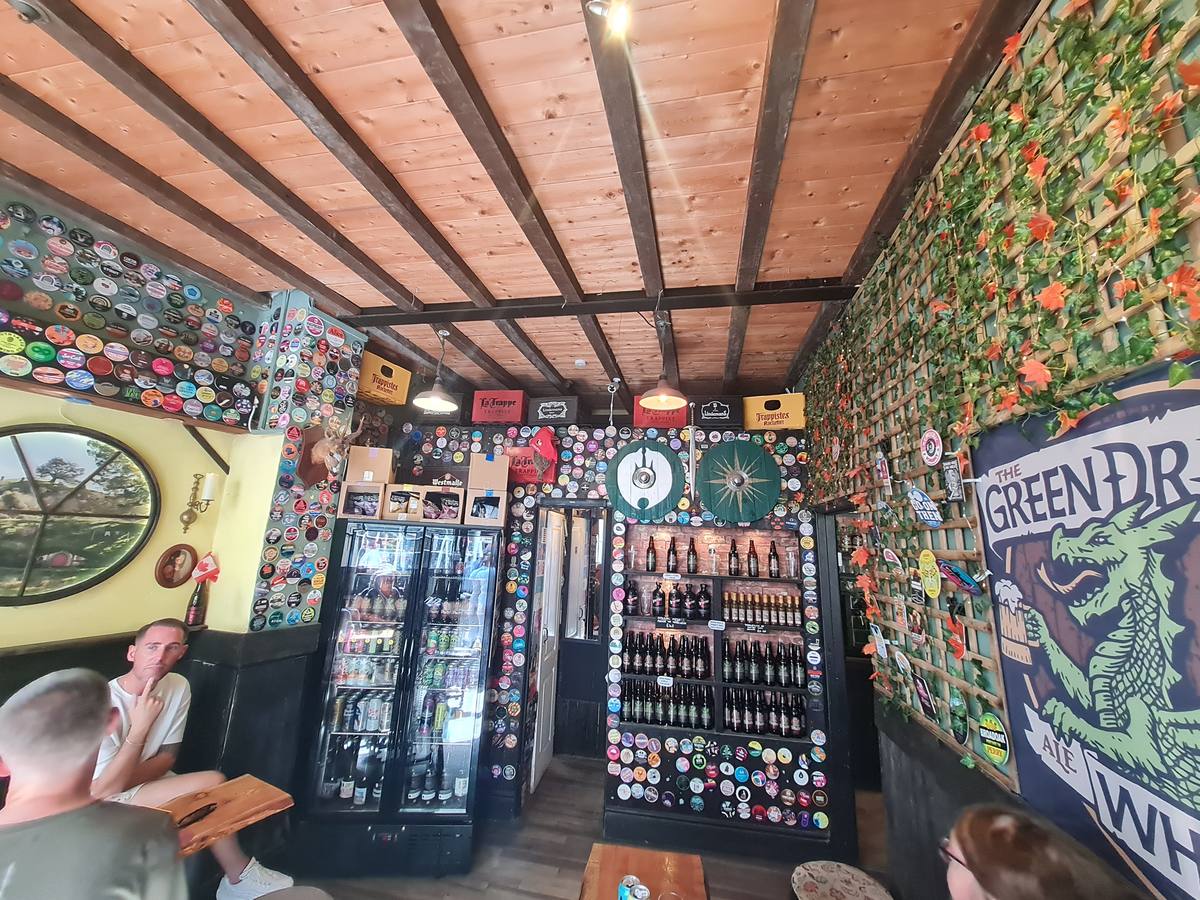 Quirky seating and bottle-lined shelving inside the Green Dragon Ale House, Whitby