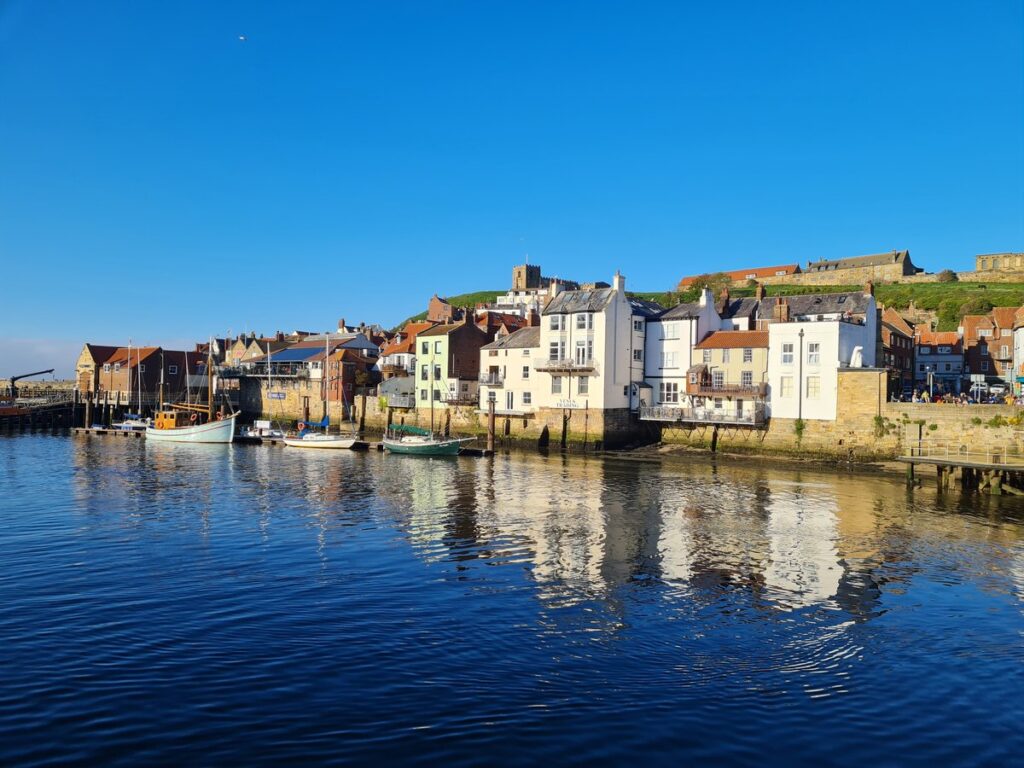 Whitby harbour with the East Cliff and the abbey on the skyline, seen from the west side