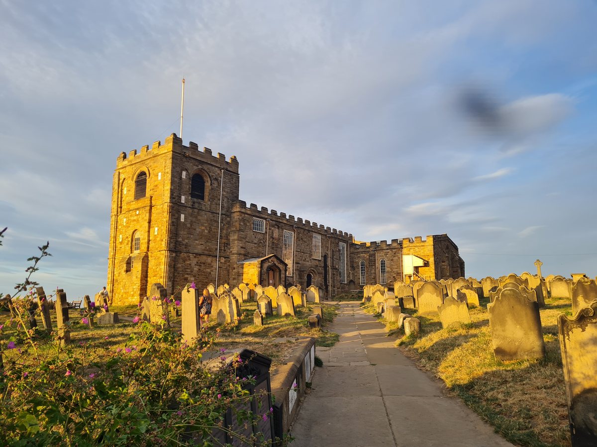 St Mary's Church and its graveyard on Whitby's East Cliff in golden light